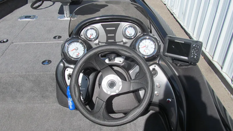 Slide: The Image of 2024 Tracker Pro Team 175 TF boat dashboard with steering wheel and gauges. - 6