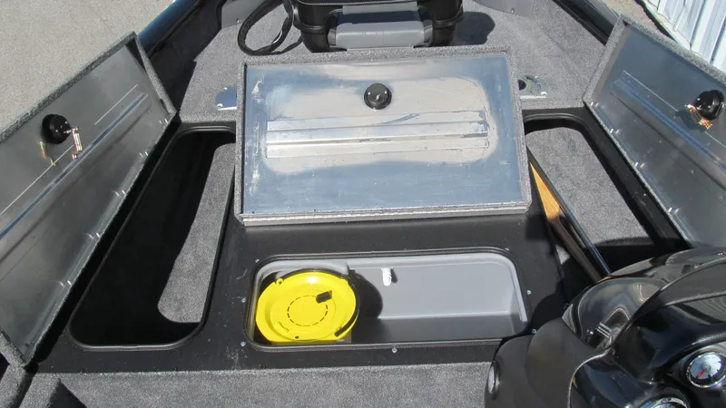 Slide: The Image of 2024 Tracker Pro Team 175 TF boat interior with storage compartments and fishing gear. - 8