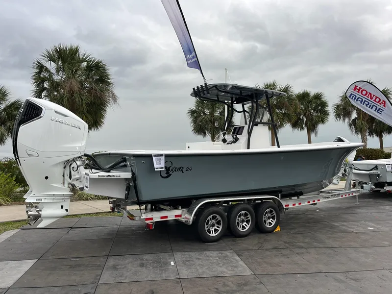 Slide: The Image of 2025 C-Hawk 29 Center Console boat on trailer, displayed outdoors with palm trees. - 2