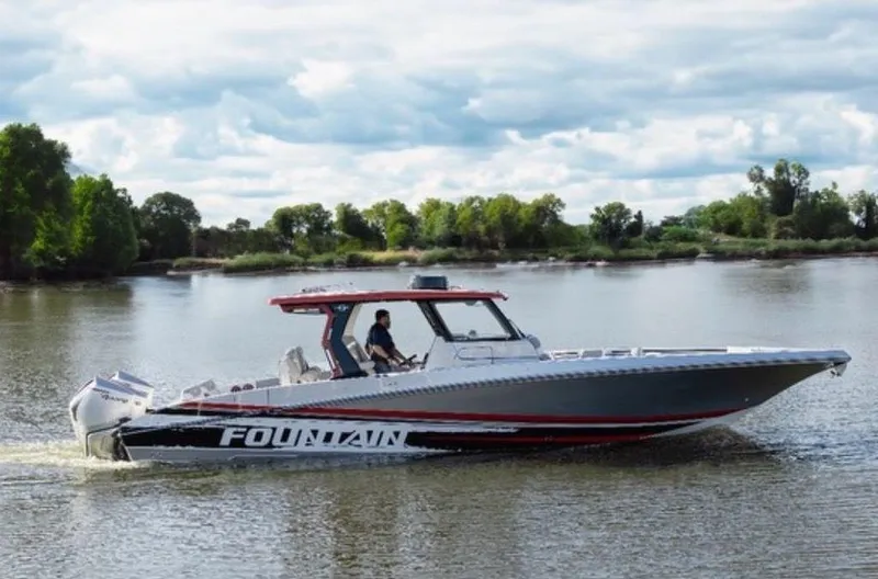 The Image of 2024 Fountain 38 SCX boat on trailer, sleek design, overcast sky background. - 0
