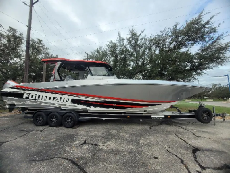 The Image of 2024 Fountain 38 SCX boat on trailer, sleek design with red and black accents. - 1
