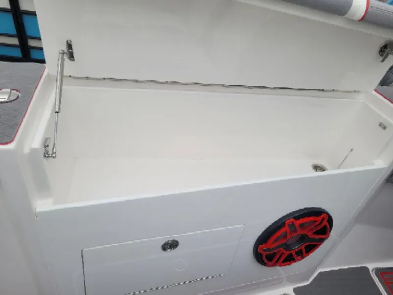 Slide: The Image of 2024 Fountain 38 SCX storage compartment with red-accented speaker detail. - 10