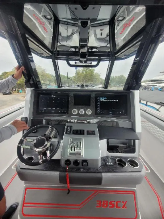 Slide: The Image of 2024 Fountain 38 SCX boat dashboard with advanced controls and navigation systems. - 12