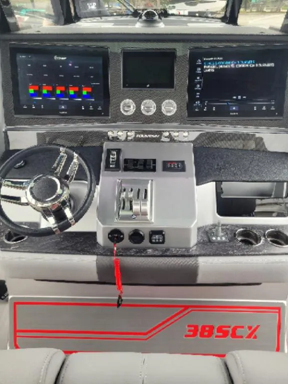 Slide: The Image of 2024 Fountain 38 SCX boat dashboard with advanced controls and dual displays. - 14