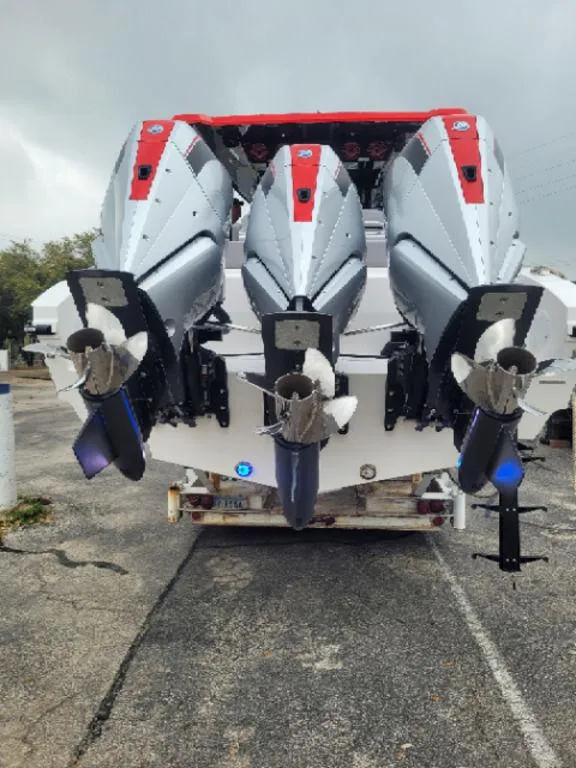 Slide: The Image of 2024 Fountain 38 SCX boat with triple outboard engines, parked on a trailer. - 17