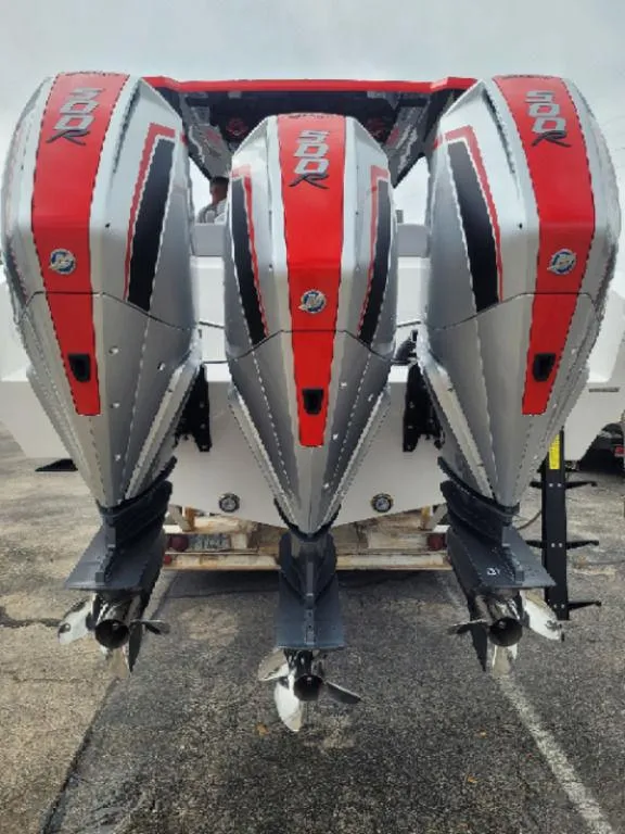 Slide: The Image of 2024 Fountain 38 SCX boat with triple outboard engines, red and silver design. - 18