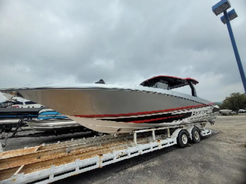 Slide: The Image of 2024 Fountain 38 SCX boat on trailer, sleek design, overcast sky background. - 20