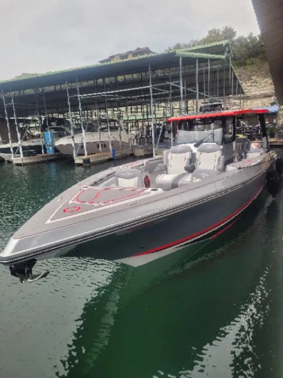 Slide: The Image of 2024 Fountain 38 SCX boat docked in marina, featuring sleek design and modern amenities. - 24