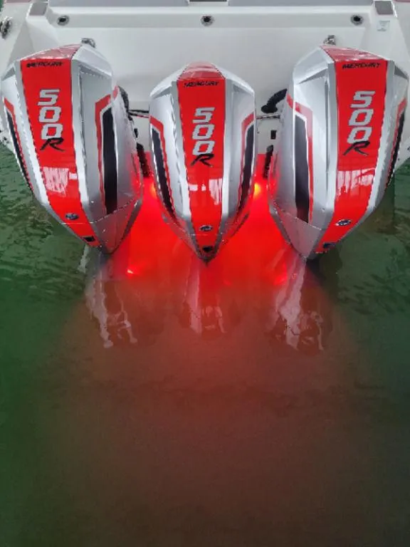 Slide: The Image of 2024 Fountain 38 SCX with triple 500R engines, illuminated in red, on water. - 29