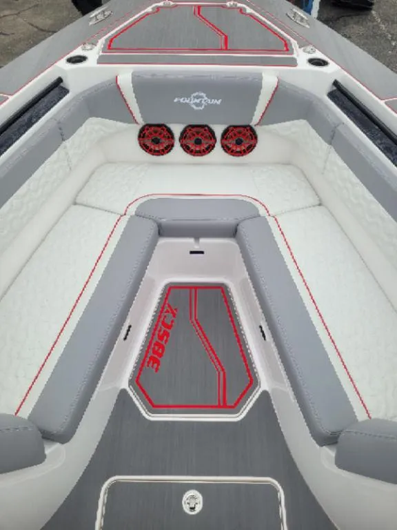 Slide: The Image of 2024 Fountain 38 SCX boat interior with gray and red seating and speakers. - 6