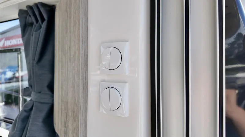 Slide: The Image of Interior view of 2025 Bayliner TROPHY 25 EXPLORER with modern light switches. - 10