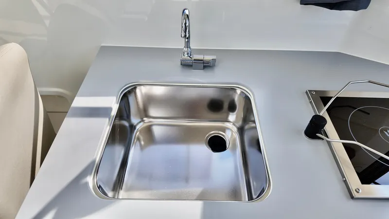 Slide: The Image of Stainless steel sink and faucet in 2025 Bayliner TROPHY 25 EXPLORER boat kitchen. - 20
