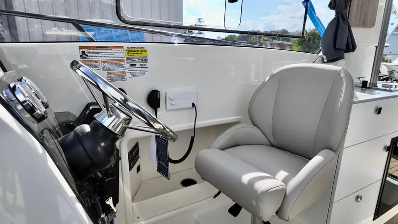 Slide: The Image of 2025 Bayliner TROPHY 25 EXPLORER helm with steering wheel and comfortable captain's chair. - 23