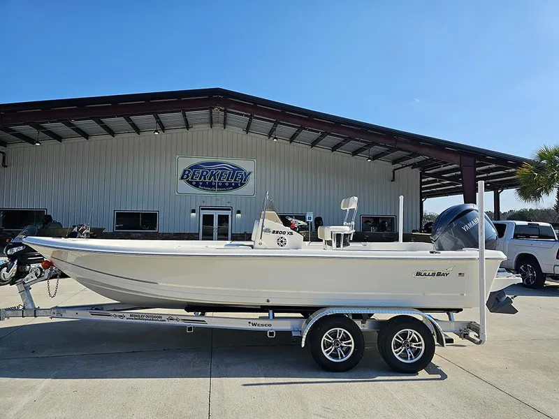 The Image of 2025 Bulls Bay 2200 XS boat on trailer outside dealership. - 1