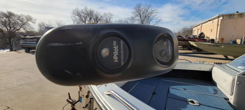 Slide: The Image of 1995 Crestliner Sportfish 1750 with iPilot motor, parked outdoors on a sunny day. - 12