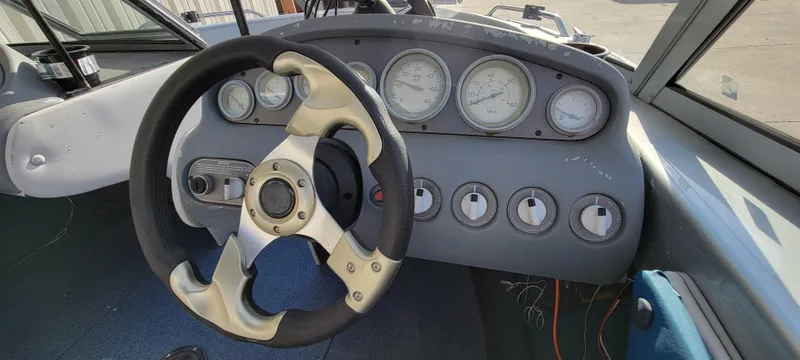 Slide: The Image of 1995 Crestliner Sportfish 1750 dashboard with steering wheel and gauges. - 20