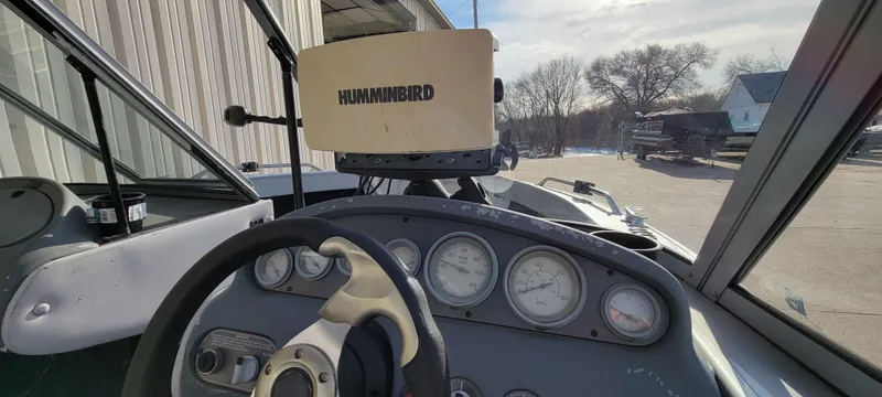 Slide: The Image of 1995 Crestliner Sportfish 1750 dashboard with Humminbird fish finder and steering wheel. - 21