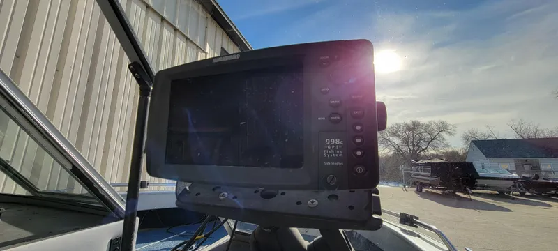 Slide: The Image of 1995 Crestliner Sportfish 1750 boat with a mounted fish finder under bright sunlight. - 22