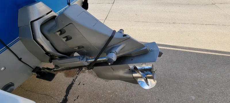 Slide: The Image of Outboard motor of a 1995 Crestliner Sportfish 1750 boat on pavement. - 5