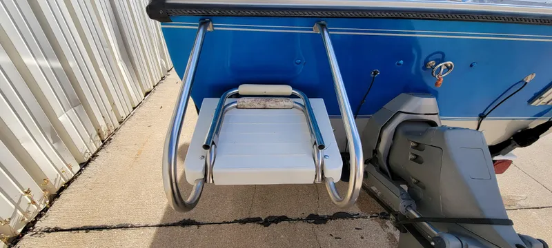 Slide: The Image of 1995 Crestliner Sportfish 1750 boat with swim platform and ladder, blue exterior. - 6