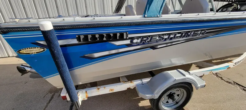 Slide: The Image of 1995 Crestliner Sportfish 1750 boat on trailer, blue and silver design. - 8