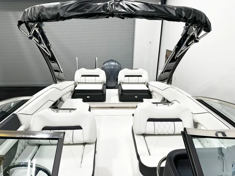 Slide: The Image of 2025 Regal LX4 boat interior with white seating and black accents. - 10