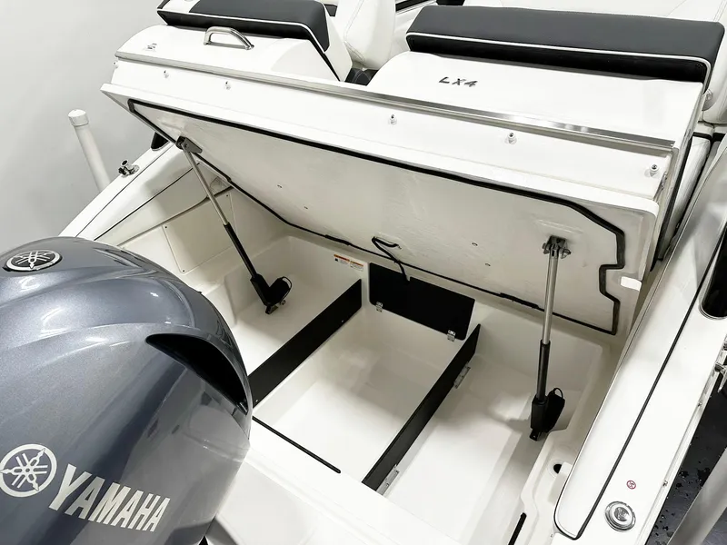 Slide: The Image of 2025 Regal LX4 boat with Yamaha engine, open storage compartment, sleek design. - 12