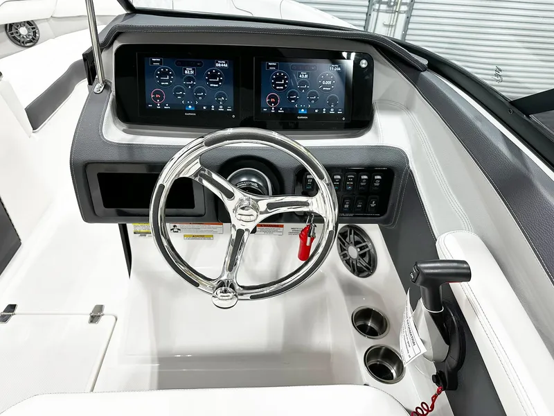 Slide: The Image of 2025 Regal LX4 boat dashboard with dual displays and sleek steering wheel. - 6