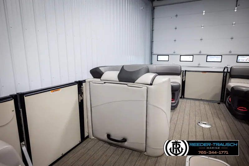 Slide: The Image of 2021 Avalon Catalina QL pontoon boat interior with plush seating in a showroom. - 21