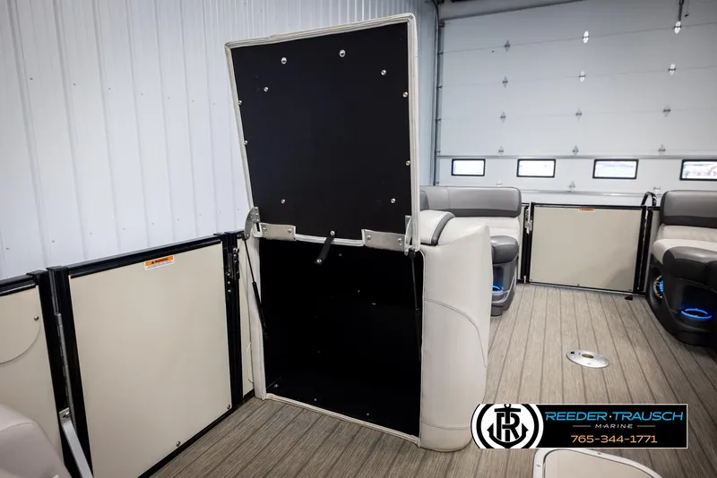 Slide: The Image of 2021 Avalon Catalina QL interior with open storage compartment in a showroom setting. - 22