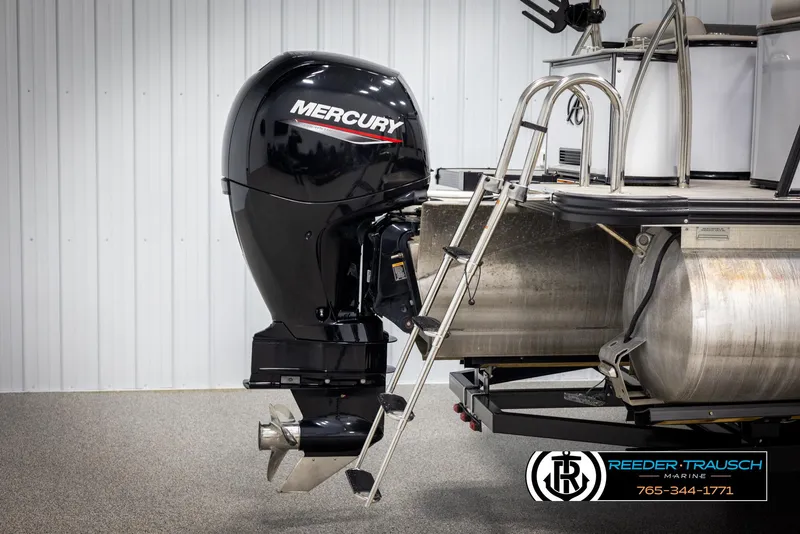 Slide: The Image of 2021 Avalon Catalina QL with Mercury outboard motor and ladder, displayed indoors. - 41