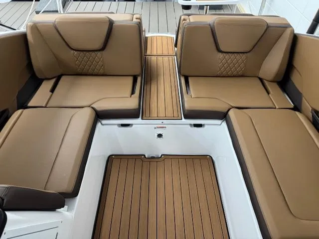 Slide: The Image of 2025 Yamaha Boats 252SD interior with brown seating and wood-style flooring. - 11