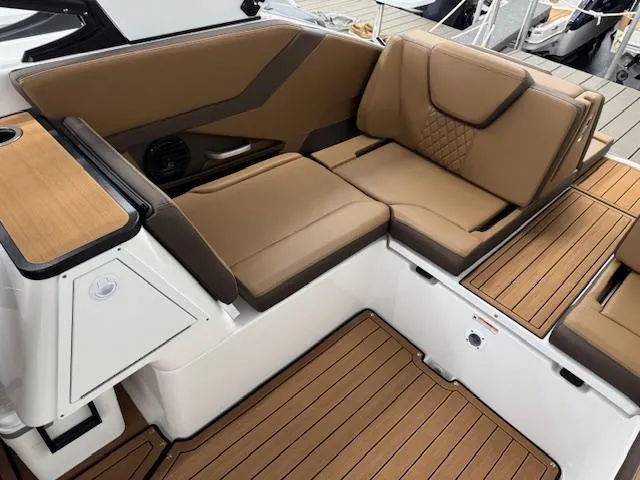 Slide: The Image of 2025 Yamaha Boats 252SD interior with tan seating and wood accents. - 13