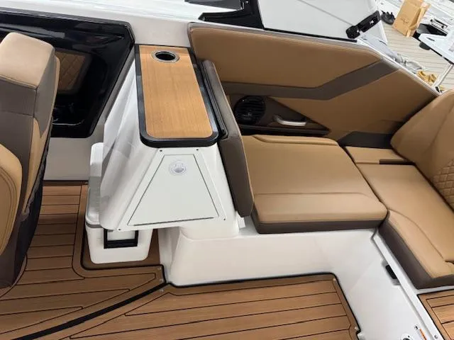 Slide: The Image of 2025 Yamaha Boats 252SD interior with tan seating and wood accents. - 14