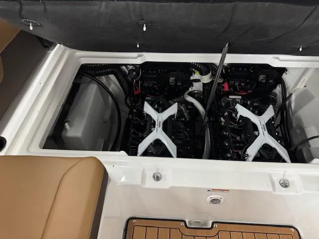 Slide: The Image of 2025 Yamaha Boats 252SD engine compartment with dual engines and tan seating. - 15