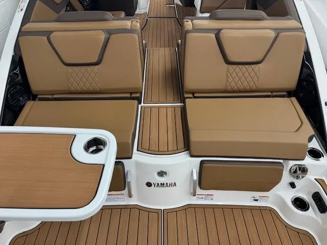 Slide: The Image of 2025 Yamaha Boats 252SD interior with tan seating and wood-style flooring. - 17
