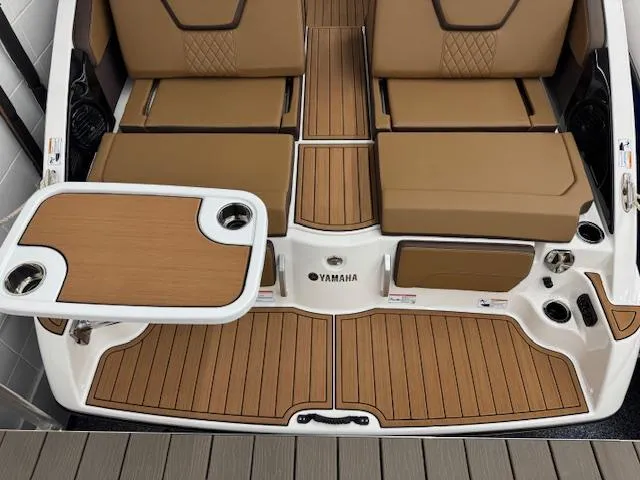 Slide: The Image of 2025 Yamaha Boats 252SD interior with tan seating and integrated table. - 21