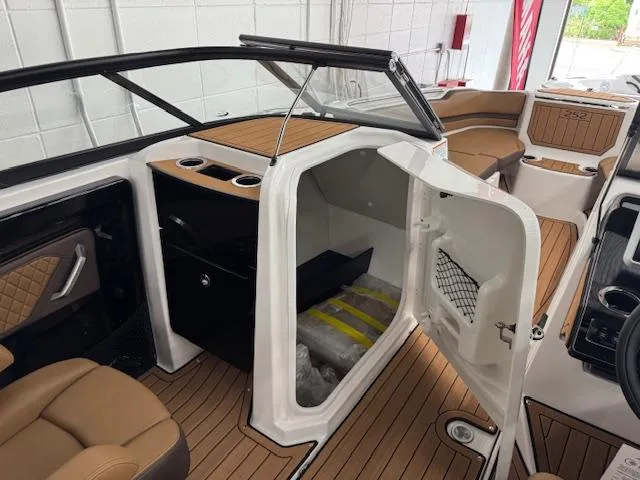 Slide: The Image of 2025 Yamaha Boats 252SD interior with open storage compartment and luxurious seating. - 7