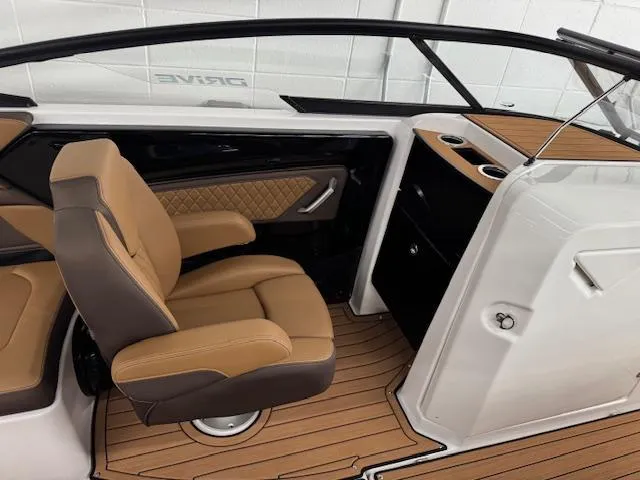 Slide: The Image of 2025 Yamaha Boats 252SD interior with tan seating and wood-style flooring. - 8