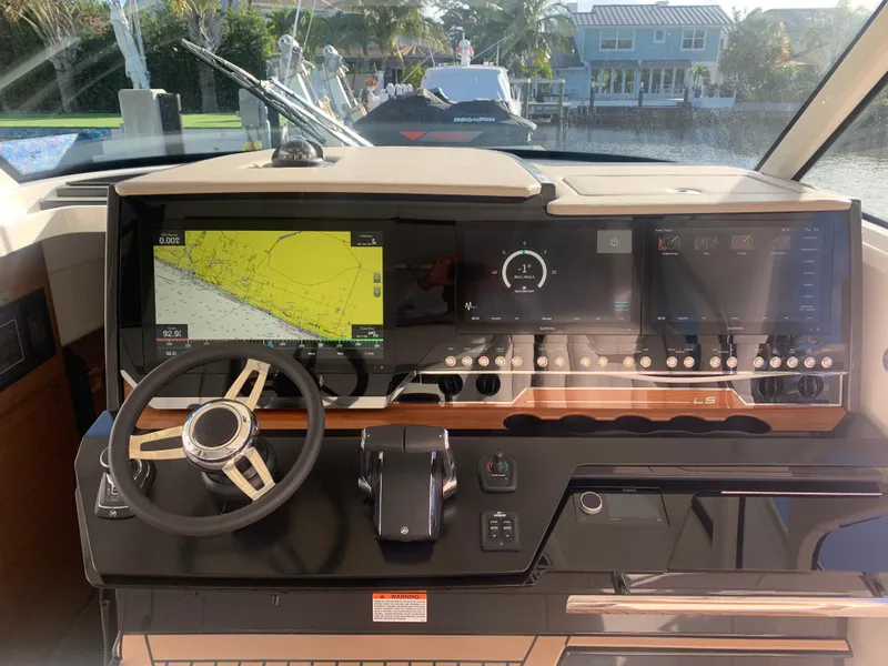 Slide: The Image of 2022 Tiara Yachts 48 LS helm with advanced navigation and control systems. - 11