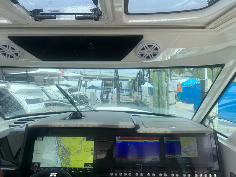 Slide: The Image of Interior view of 2022 Tiara Yachts 48 LS dashboard with navigation screens. - 13