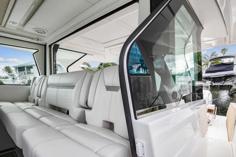 Slide: The Image of 2022 Tiara Yachts 48 LS interior with luxurious white seating and modern design. - 14