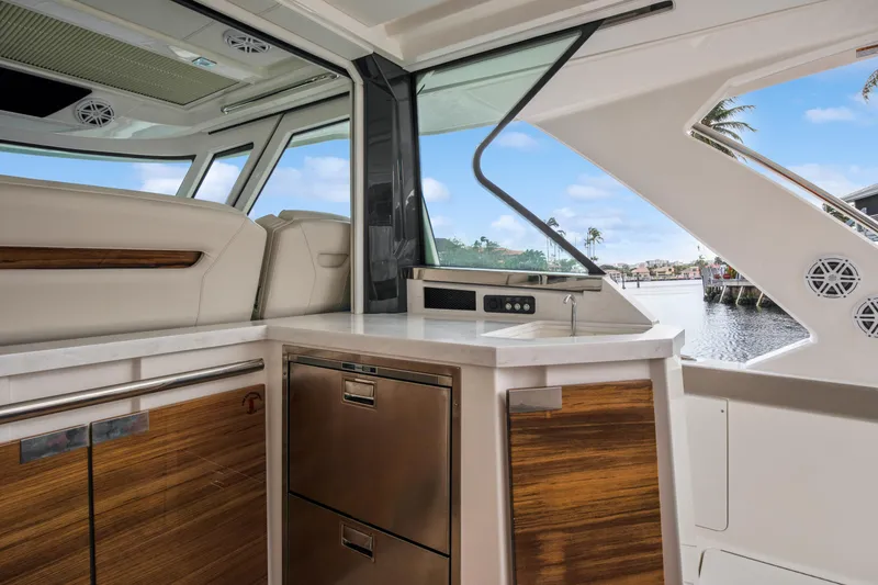Slide: The Image of 2022 Tiara Yachts 48 LS interior with modern kitchen and waterfront view. - 15