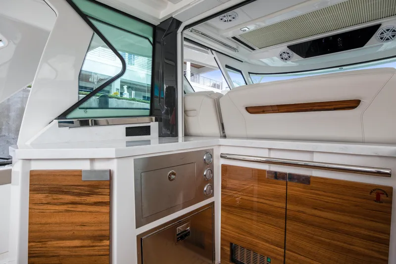Slide: The Image of Interior of 2022 Tiara Yachts 48 LS, featuring sleek wood and stainless steel finishes. - 16