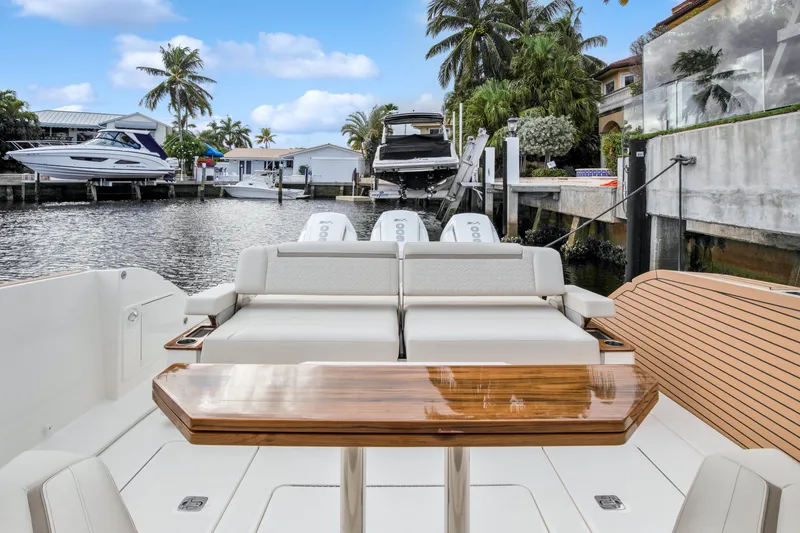 Slide: The Image of 2022 Tiara Yachts 48 LS luxury boat with elegant seating and waterfront view. - 18