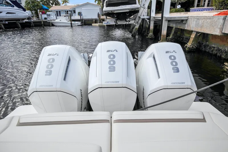 Slide: The Image of 2022 Tiara Yachts 48 LS with triple Mercury 600 outboard engines docked in marina. - 21
