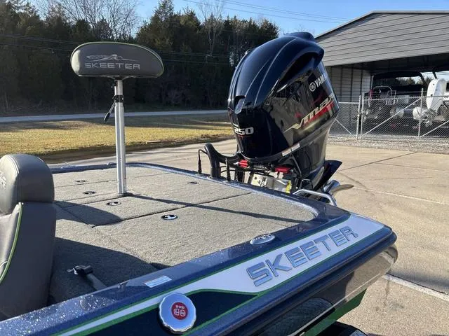Slide: The Image of 2019 Skeeter ZX250 boat with Yamaha engine, parked outdoors. - 13