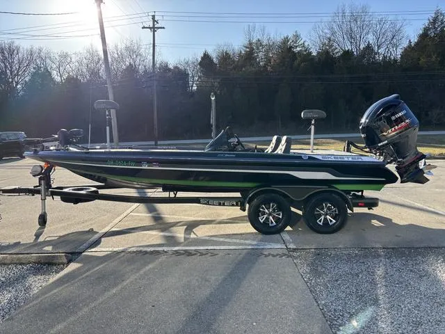 Slide: The Image of 2019 Skeeter ZX250 bass boat on trailer, parked outdoors in sunlight. - 15