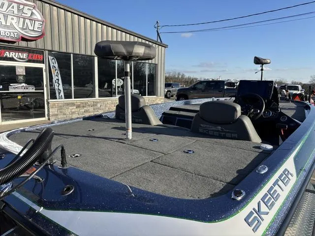 Slide: The Image of 2019 Skeeter ZX250 boat at marina, showcasing spacious deck and seating. - 4