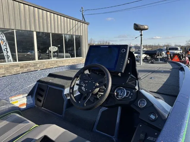 Slide: The Image of 2019 Skeeter ZX250 boat dashboard with steering wheel and navigation system. - 6